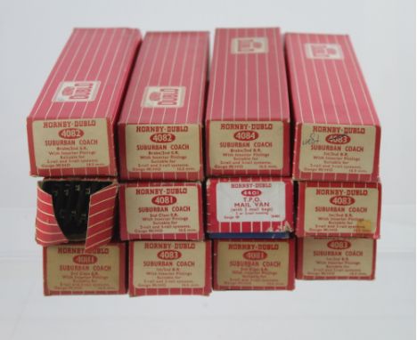 A collection of Hornby Dublo model railways coaches and track comprising three 4081 Suburban Coaches, two 4082 Suburban Coach
