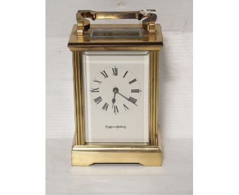 A mid to late 20th century Mappin &amp; Webb brass carriage clock with lever escapement the white enamel face set with Roman 