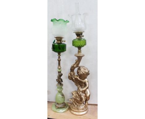 An early/mid-20th century green glass paraffin lamp with frosted white and green glass shade surmounting an earlier green ony