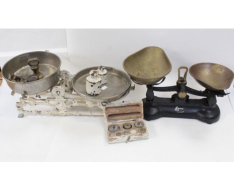 A set of cream painted cast iron balance scales and weights, width 52cm and a more modern Librasco black painted cast iron ba