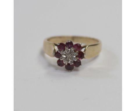 A 9ct gold ruby and chip diamond daisy cluster ring, size N, approx 3g.