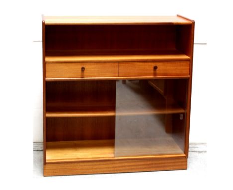 A modern teak Parker Knoll floor standing bookcase with open book well surmounting two central frieze drawers over a fixed sh