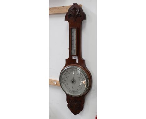 An early 20th century mahogany banjo aneroid barometer/thermometer with stylised leaf decoration top and bottom, height 81.5c