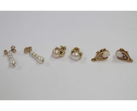 Three pairs of yellow metal earrings to include a four pearl drop pair, a pair of solitaire stud earrings, and a pair of whit