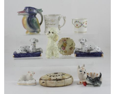 A quantity of ceramics to include a pair of 20th century Staffordshire-style reclining dogs, a Hummel cat playing with a ball