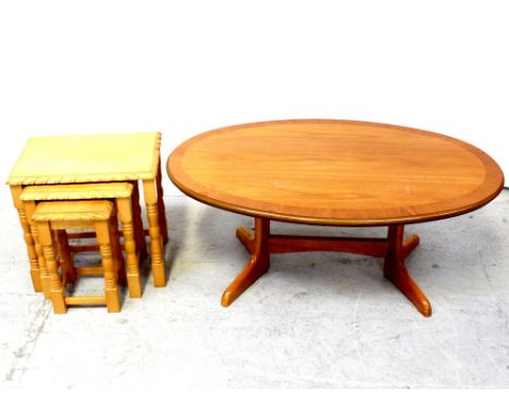 A nest of three light beech occasional tables and an oval coffee table on twin pillar supports, length approx 110cm (2).