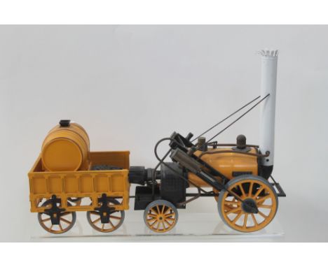 A spirit-driven mechanical working scale model of Stephenson's Rocket in yellow livery, length 42.5cm.