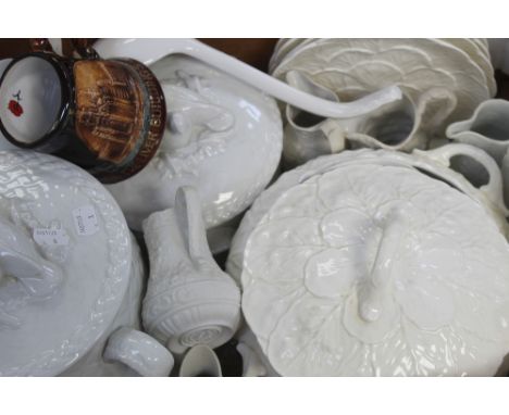 A small group of blanc de chine ceramics including a graduated pair of Worcester oven-to-table ware casserole dishes with pig