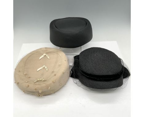 Lot includes Arnold Constable velvet cream colored hat with fishnet veil; Mr. John Classic black fabric pill box hat; and Arn