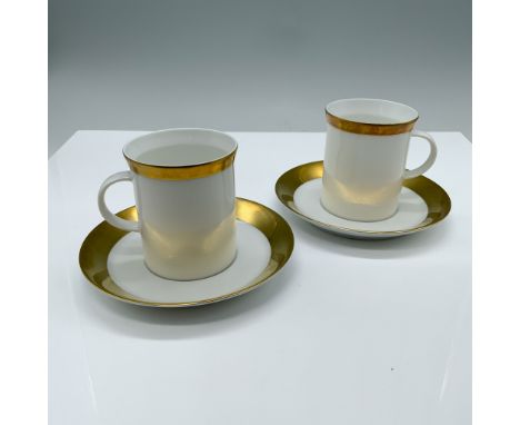 This German Porcelain set features a sophisticated gold rim design. Includes 2 demitasses (3.25"H x 2.75" dia. with matching 