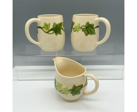 Lovely trio of cups with a vine pattern all throughout the body that includes two large mugs and one creamer jug. Franciscan 