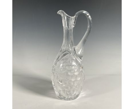 Beautifully cut small pitcher made of clear glass. Either side is adorned with an etched grape bunch with leaves. The remaind