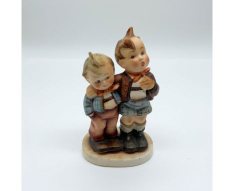 This delightful Goebel porcelain figurine depicts two small children in traditional attire. Standing at 5.5" in height, it is