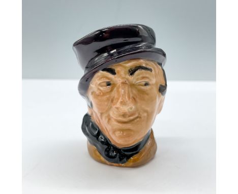 Figural jug of a Charles Dickens character from The Pickwick Papers. Orange coat with a black scarf and hat. A plain black ha