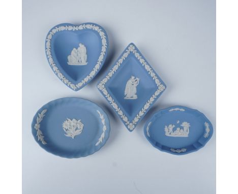 A collection of four iconic Wedgwood Jasperware jewelry dishes, crafted in the classic blue and white color scheme, including