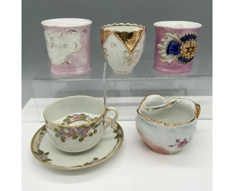 Handsome collection of mugs that consists of a baby pink cup that has a text that reads A Present and a Made in Germany backs