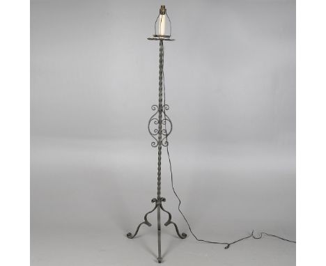 A FRENCH MEDIEVAL STYLE METAL FLOOR STANDING LAMPthe spirally turned central shaft terminating in three scrolling feet and th