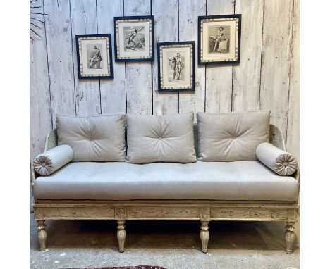 A LATE 19TH CENTURY SWEDISH GUSTAVIAN PAINTED WOOD TRAGSOFAthe sofa with scrolling sides, raised on eight tapering, foliate c
