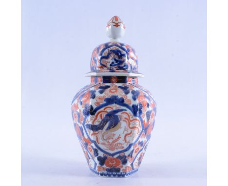 A JAPANESE IMARI PORCELAIN LIDDED VASEof baluster form, with domed cover with faceted finial, the body decorated with a styli