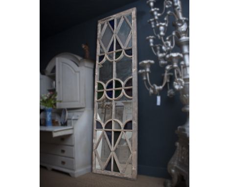 A VERY LARGE FRENCH CARVED WOOD MIRRORED AND STAINED GLASS PANELarchitectural, of rectangular form with shaped plates and sta