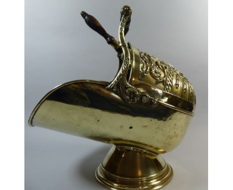 An Impressive Brass and Walnut Helmet Shaped Coal Scuttle. Deeply Embossed with Dual Griffins, Urn, Swags and Scrolling Decor