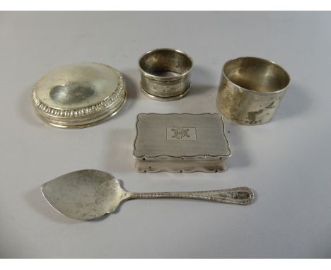 A Collection of Silver Item to Include Snuff Box (Hinge Missing) Two Napkin Rings, SIlver Lid and Spoon.