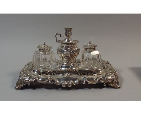 A Good Silver Desk Top Inkstand with Centre Pen Holder having Removable Candlestick and Flanked by Two Silver Topped Glass In