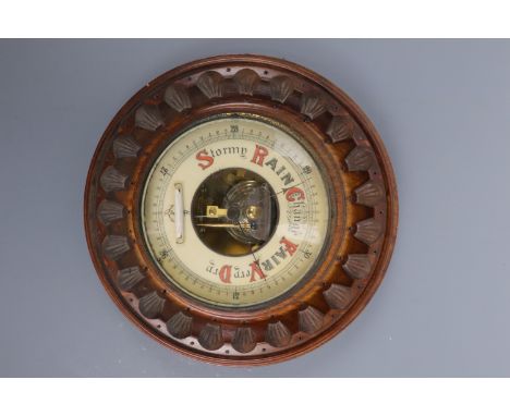 An oak carved barometer, 23 cm diameter