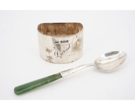 A George V silver napkin ring engraved David, Birmingham, 1919, 44.1g and a white metal teaspoon stamped 'Sterling', 9.1g