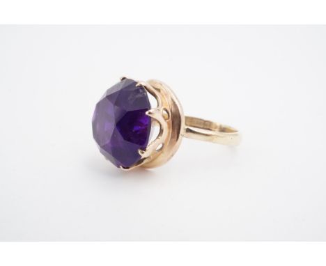 An amethyst dress ring, the 15 mm circular stone crown set on a 9 ct gold shank, O