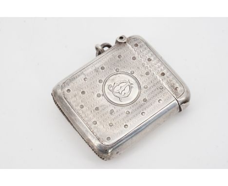 An Edwardian silver Vesta case decorated in a polka dot pattern on an engine-turned ground centred by a circular cartouche wi