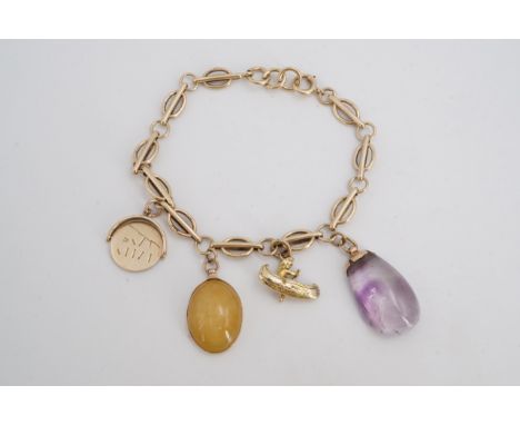 A 9 ct gold charm bracelet with amethyst and other charms, 13.4 g