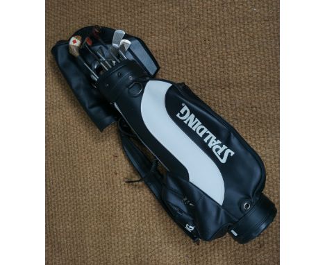 Vintage golf clubs including Golf Craft of Scotland and Peter Butler, in a Spalding golf caddy