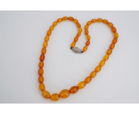 A vintage amber bead necklace, 49 cm, largest bead 12 x 16 mm, 20.2 g