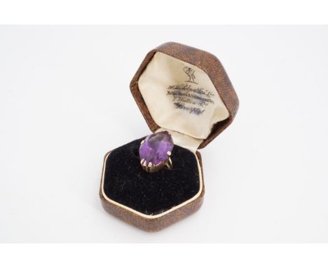 An amethyst cocktail ring, the navette shaped stone (21 x 13 mm) set on a yellow metal shank, O/P