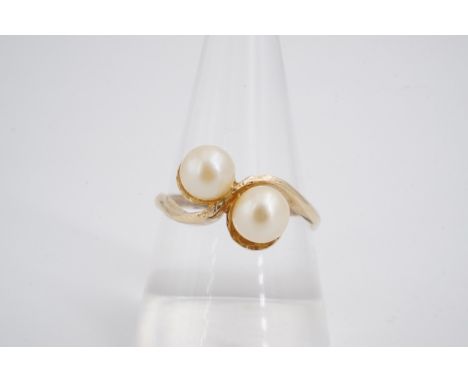 A twist-set pearl dress ring, the 5 mm twin pearls set on a 9 ct gold shank, O/P