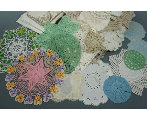 A quantity of vintage hand-crocheted and embroidered doilies or jar covers including one pink example decorated with pansies