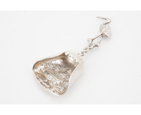 A Dutch silver caddy spoon, decorated in relief depiction of a wind- or water-mill, the stem in the form of a bird, London im