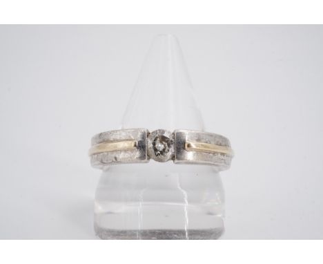 A contemporary diamond solitaire ring, the brilliant-cut diamond of approximately .50ct, held in a captive setting on the bis