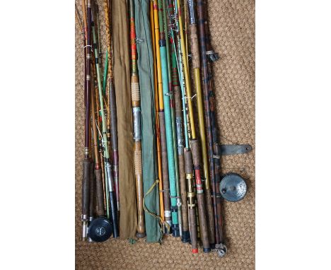 A quantity of vintage fishing rods including Greenheart, fibre glass etc.