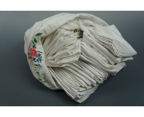 A large quantity of vintage whitework napkins contained within a vintage pillow case
