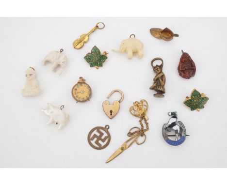 A collection of vintage charms, badges and miniatures, including a mother-of-pearl piglet, a miniature gilt metal pair of cha