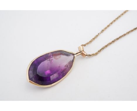 An amethyst and yellow metal pendant, the teardrop shaped stone (23 x 31 mm) bezel-set, together with a rope-link neck chain
