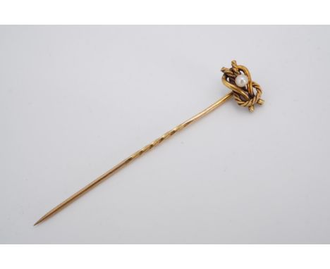 A Victorian pearl and yellow metal stick pin, the pearl set within an open reef knot of cabled and plain gold wire, marked 15