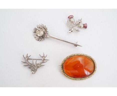 A silver and citrine thistle-form brooch or kilt pin (7 cm), a silver and amethyst coloured glass thistle brooch, an agate br