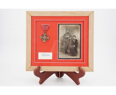 A framed French Croix de Guerre medal and portrait postcard