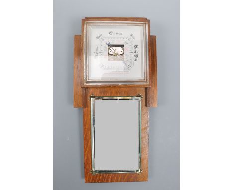 A 1940s oak barometer / mirror, 38 cm high