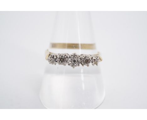 A five-stone diamond ring, the diamonds illusion-set on an 18 ct gold shank, Q/R, 3.3 g