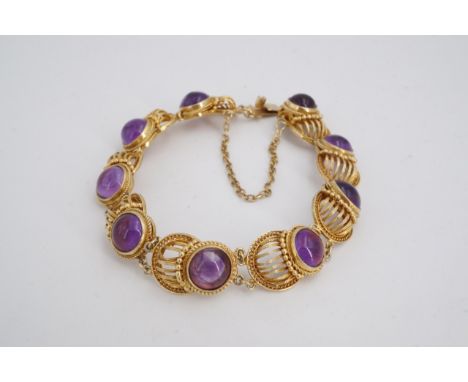 An amethyst and gilt white metal bracelet, comprising circular cabochons set on convex cannetille links