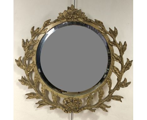 A circular wall mirror with laurel garland surround, 65 cm x 68 cm